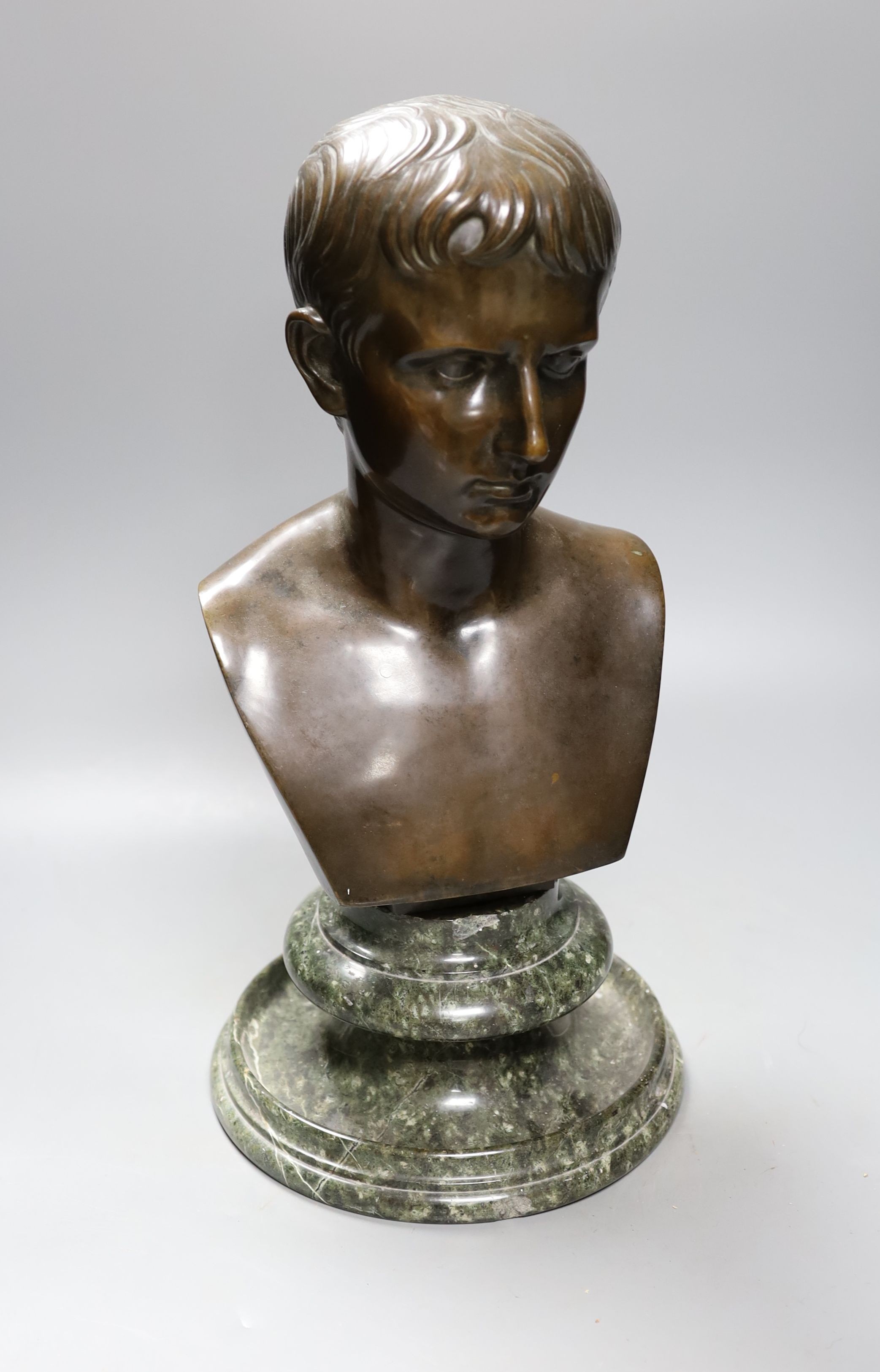 A bronze bust of Octavian, on associated marble socle, 42 cms high including stand.